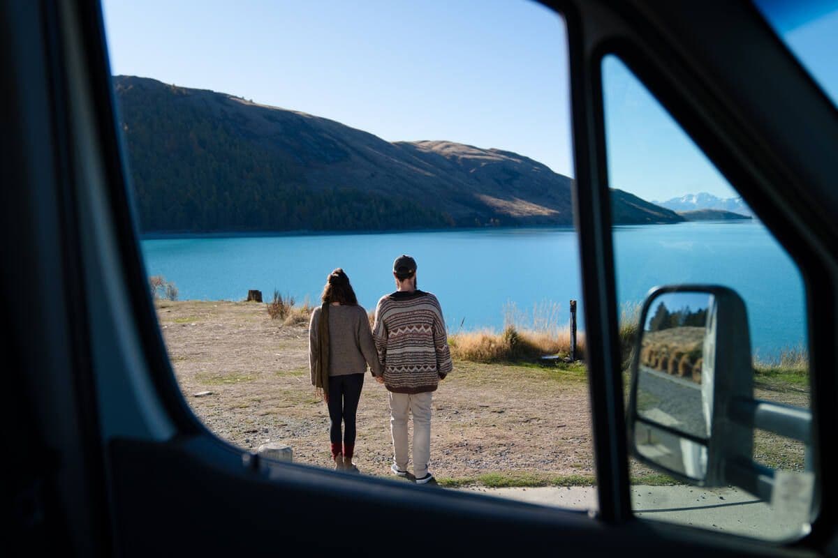 Couple holding hands looking into view
